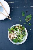 Pho Bo (Vietnamese noodle soup) with chicken, bean sprouts, herbs and lemongrass