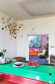 View into living room from loft-apartment kitchen with artistic wall decoration