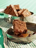 Brownies with butterscotch sauce in a tin for a picnic