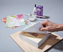 Instructions for making a DIY wooden frame covered in wallpaper remnants or wrapping paper