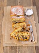 Fruit cake with icing sugar on a piece of baking paper
