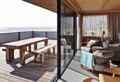 Camber Sands Beach Houses, Rye, United Kingdom. Architect: Walker and Martin, 2014; View looking out from living room over terrace and west across beach to the sea