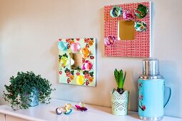 Hand-decorated mirrors above sideboard; retro thermos flask and house plants