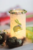 Candle lantern covered in fabric decoupage with felt Easter bunny motif