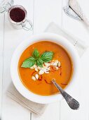 Tomato and pumpkin soup with saffron in a white bowl