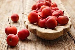 Ornamental apples in a wooden dish