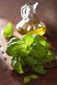 Fresh basil leaves and olive oil in a glass carafe