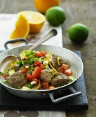 Veal in a citrus fruit sauce with tomatoes, spring onions and avocado