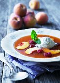 Cold peach soup with raspberries and ice cream