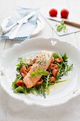 Steamed salmon on a bed of rocket