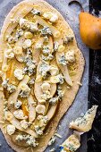 Pizza with pears, blue cheese, garlic and cheese, unbaked