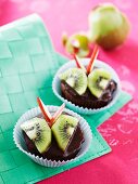 Chocolate muffins decorated with kiwi and apple 'butterflies'