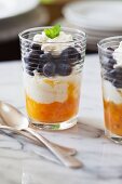 Two glasses of blueberry and mango parfait