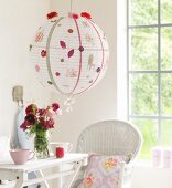 White, spherical paper lampshade decorated with various motifs