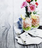 Two glasses of prawn cocktail on salad