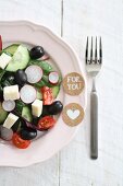 A salad of cucumbers, tomatoes, olives, radishes and feta cheese