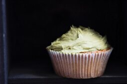 A cupcake with matcha frosting
