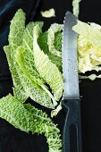Sliced savoy cabbage with a knife