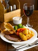 Roast beef with sides and red wine