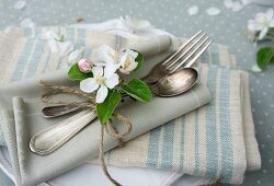 Place setting with apple blossom and napkins