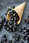 An ice cream cone with blackcurrants