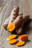 Fresh turmeric roots on a wooden surface