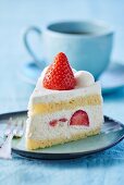 A slice of strawberry cream cake