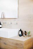 Eleganter Waschtisch aus Holz mit weißem Waschbecken und Wandverkleidung