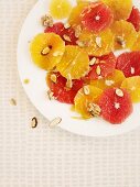 Orange salad with honey, almonds and walnuts (seen from above)