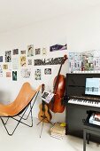 Butterfly chair with pale brown leather cover next to musical instruments