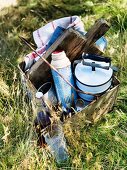 Picnic utensils in rusty metal container