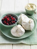 Meringues with berry compote and whipped cream