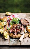 Grilled, marinated beef steaks with garlic bread
