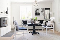 Black round table and white armchairs in comfortable living area