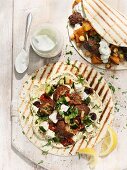 Wraps with falafel and lamb and chicken skewers