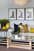 Striped sofa, glass table and yellow cushions and vases