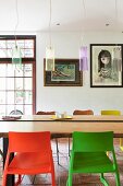 Retro pendant lamps above table with live-edge wooden top, plastic chairs in foreground and modern art in background