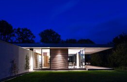 Classic modern house at night with illuminated interior