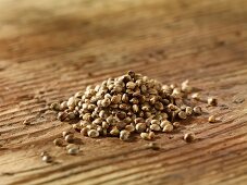 A pile of hemp seeds on a wooden surface