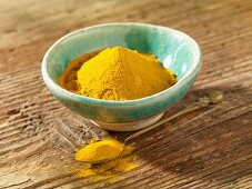 Turmeric powder in the ball and on a spoon
