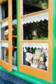 View of kitchen utensils through painted lattice window