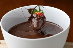 A wave of chocolate with a strawberry