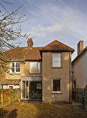 View from garden of 30s semi-detached house with contemporary conservatory extension