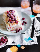 Sesame praline meringue roulade with rosewater raspberries