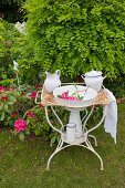 Wash basin and pitcher on vintage metal stand in garden