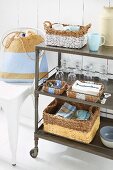 Wicker baskets, glasses, cups and crockery on a serving trolley