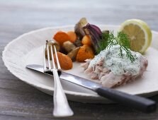 Fish with a dill sauce and a side of vegetables