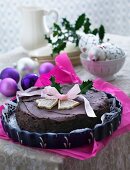 A festive Christmas chocolate cake decorated with a ribbon