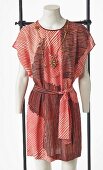 Red striped dress and costume jewellery necklace on mannequin without head