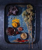 Dried herbs and spices on a blue tray